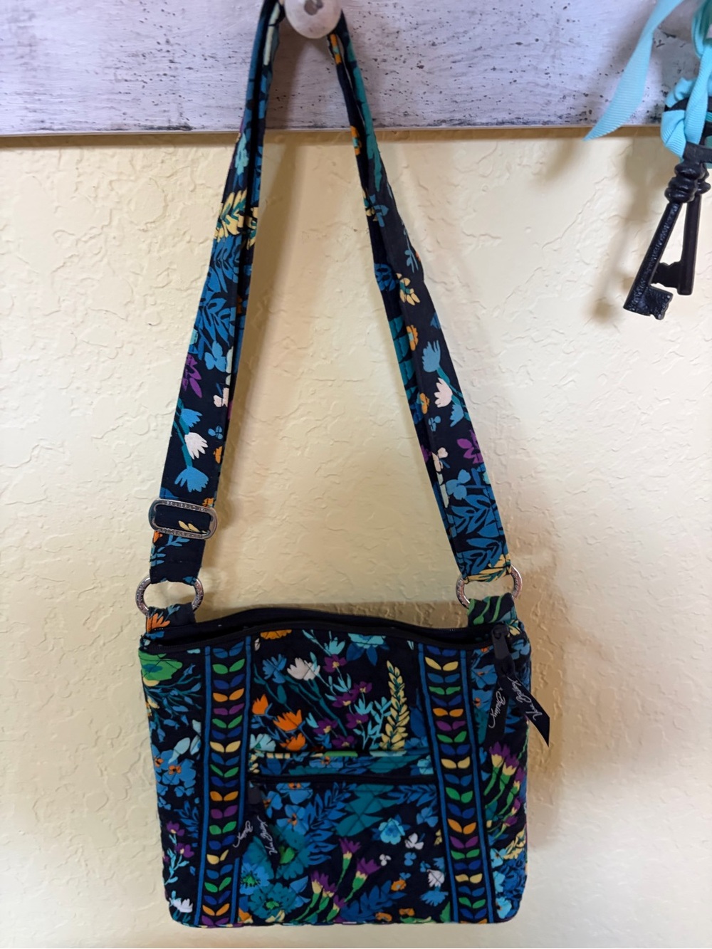 Vera Bradley purse in bright flowers with a navy background. 11 x 10.5